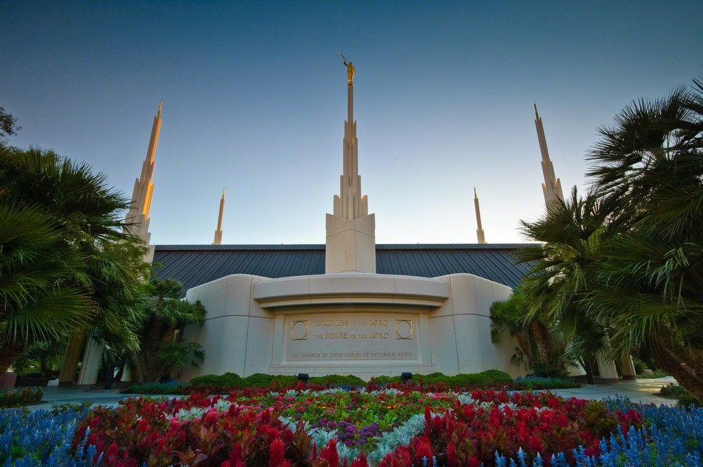 The Las Vegas Nevada Temple entrance with palm trees and colorful flower beds